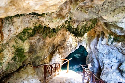 a cave with a bridge in the middle at Hotel Casa Tortuga Tulum - Cenotes Park Inclusive in Tulum