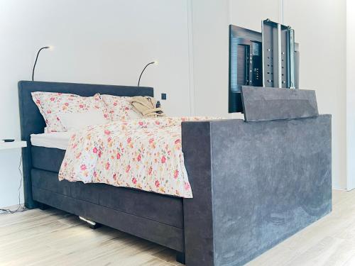 a bedroom with a bed with a red and white blanket at Luxurious Escape - Room LoveSerenity with pool and jacuzzi in Brussels