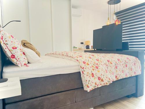 a bedroom with a bed with a tv on it at Luxurious Escape - Room LoveSerenity with pool and jacuzzi in Brussels
