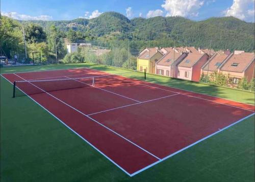 an image of a tennis court with houses in the background at Holiday Home - Italo & Dada in Soviore