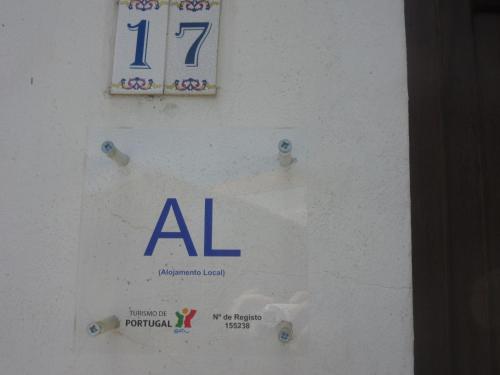 a sign on a wall with a al sign on it at Casa Eira do Povo 1 in Vale de Colmeias
