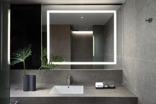 a bathroom with a sink and a mirror at Presidente InterContinental Monterrey by IHG in Monterrey