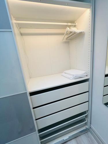 a walk in closet with white drawers at Luxurious 5Star Retreat on Westports Main Street in Westport