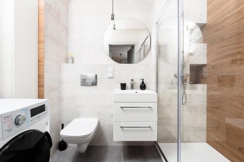 a bathroom with a toilet sink and a shower at City of the Kings - Riverside B22 in Kraków
