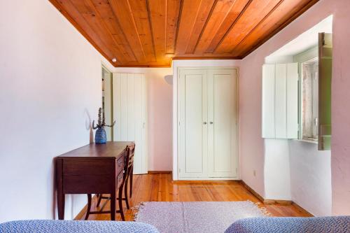 a room with a desk and a wooden ceiling at Village House in Sintra hills in Colares