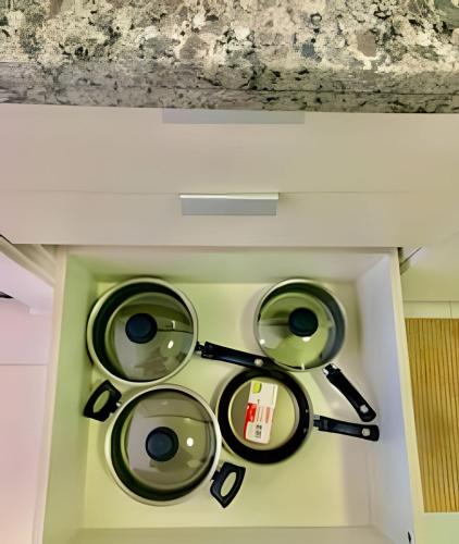 a bunch of pans on a wall in a room at Studio Vertentes in Sao Paulo