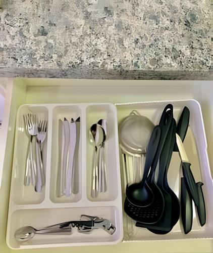 a plastic container with utensils in it at Studio Vertentes in Sao Paulo