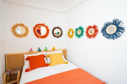 a bedroom with a bed with wreaths on the wall at Dar Sekka in Tangier