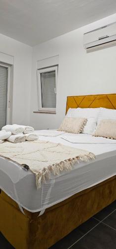 a bedroom with a large bed with white sheets at Luxury oaza Novalja in Stara Novalja
