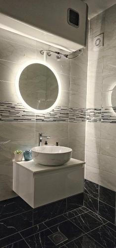a bathroom with a white sink and a mirror at Luxury oaza Novalja in Stara Novalja