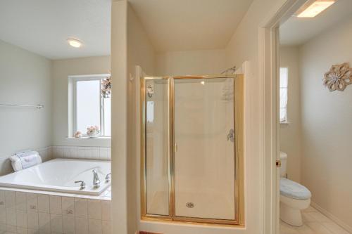 a bathroom with a shower and a tub and a sink at Moyie Springs Home with Views, Near Kootenay River! in Bonners Ferry