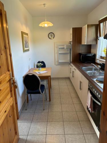 a kitchen with a table and a small table and a table at Ferienwohnung Burg Katz in Lahnstein