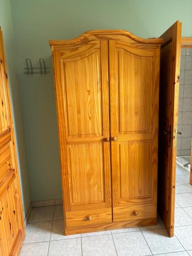 a wooden cabinet in the corner of a room at Ferienwohnung Burg Katz in Lahnstein