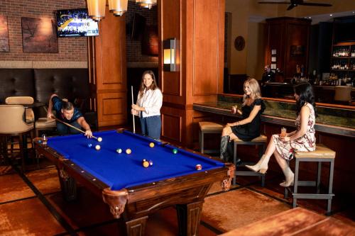 a group of women playing pool in a bar at Omni Fort Worth Hotel in Fort Worth