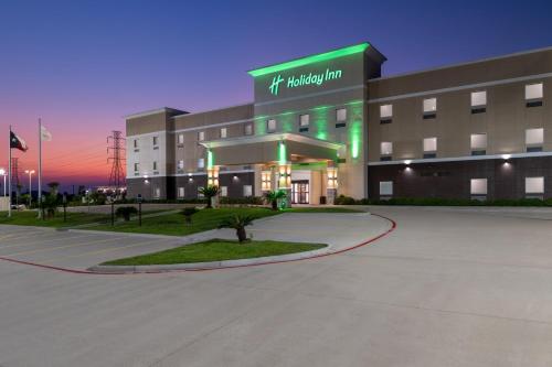 a hospital building with a green sign on it at Holiday Inn Galveston Island by IHG in Galveston