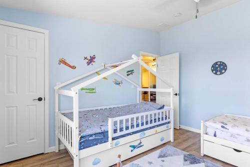 a childs bedroom with a white bunk bed at Five Points House with Amazing Views in Tehachapi