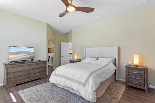 a bedroom with a bed and a flat screen tv at Five Points House with Amazing Views in Tehachapi