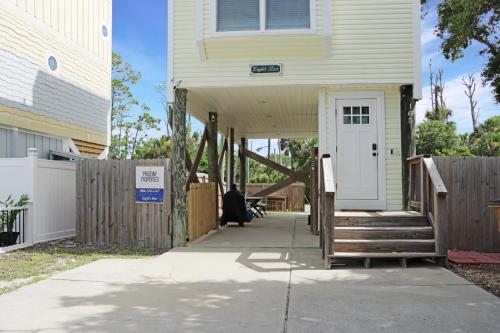 a house with a white door and a fence at Eagle's Rest by Pristine Properties Vacation Rentals in Indian Pass