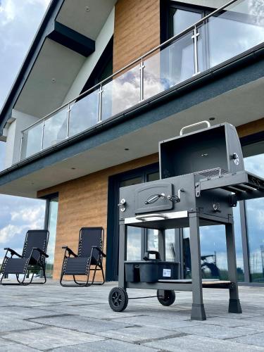 a flat screen tv on a cart in front of a building at Butter Chill House - Dom na Kaszubach in Masłowo