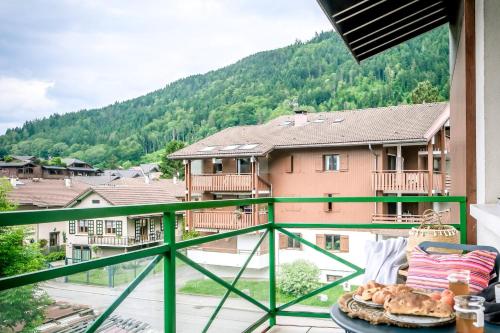 a table with a plate of food on a balcony at Slow Chalet Thônes lake & mountain 15 min to ski lift balcony parking in Thônes