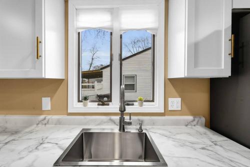 a kitchen counter with a sink and a window at Small cozy ranch in Rantoul
