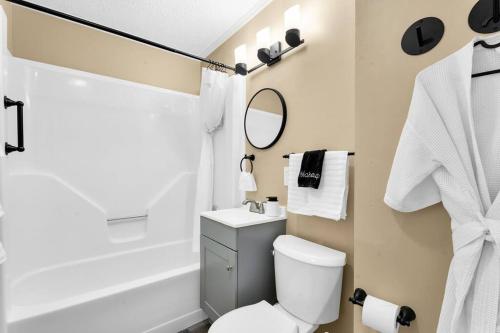 a bathroom with a white toilet and a shower at Small cozy ranch in Rantoul