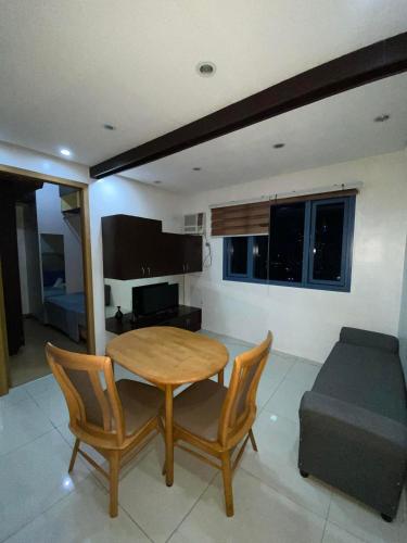 a dining room with a table and chairs and a couch at Roxas Blvd Stunning Studio Condo Near US Embassy in Manila