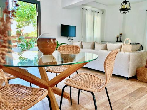 a living room with a glass table and chairs at Elios Serenity House in Neo Klima