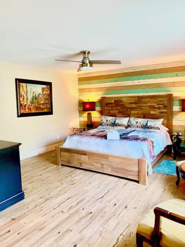a bedroom with a large bed and a flat screen tv at Oak Cottages 6 in Rockport