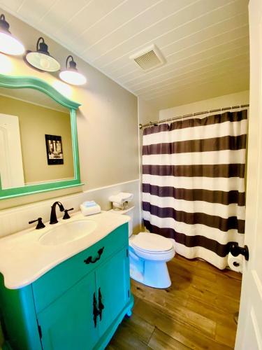 a bathroom with a sink and a toilet and a shower at Oak Cottages 6 in Rockport