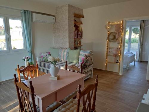 a living room with a table and a couch at EuZoea Country Home 2 in Kapandrítion