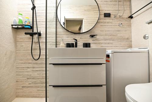 a bathroom with a sink and a mirror at New, close to the beach apartment with terrace, grill, parking, 2-rooms in Trogir