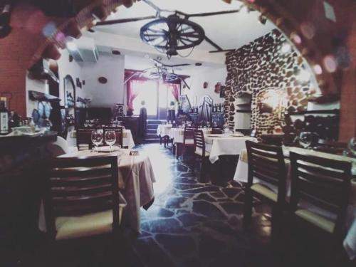 a dining room with tables and chairs in a restaurant at Villa Boutique by O Cobra in Vila de Rei