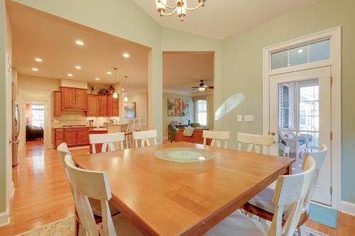 a dining room and kitchen with a wooden table and chairs at 6 Mi to Bethany Beach Family Home with BBQ and Yard in Ocean View