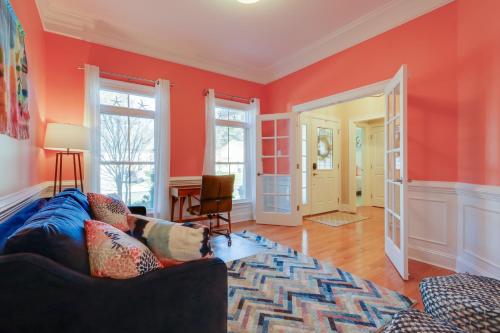 a living room with orange walls and a couch at 6 Mi to Bethany Beach Family Home with BBQ and Yard in Ocean View