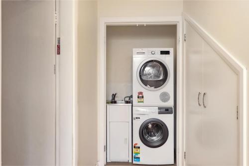 a laundry room with a washer and dryer at Prickly Pear Stays Jesmond - Short Term Accommodations in Jesmond