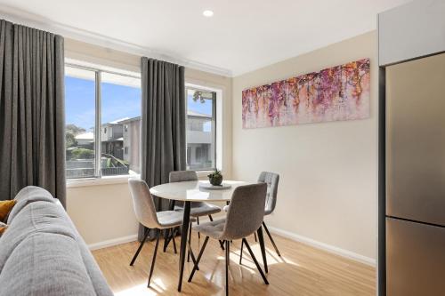 a living room with a table and chairs at Prickly Pear Stays Jesmond - Short Term Accommodations in Jesmond