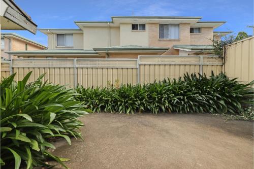 a fence in front of a house with plants at Prickly Pear Stays Jesmond - Short Term Accommodations in Jesmond