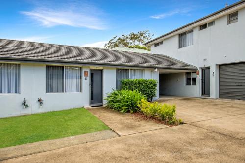 a white house with a driveway in front of it at Prickly Pear Stays Jesmond - Short Term Accommodations in Jesmond