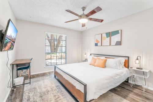 a bedroom with a bed and a ceiling fan at SoCo Chic Apartment Suites Close to Downtown in Austin