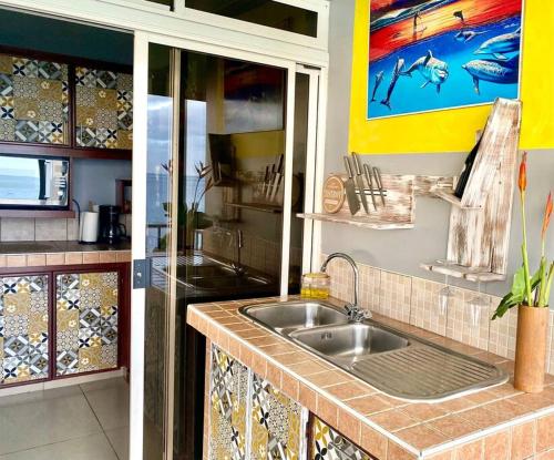 a kitchen with a sink and a counter top at Villa Maui1 in Vaihi