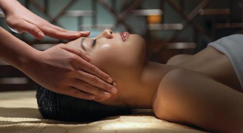 a woman getting a massage from a therapist at Mandarin Oriental, Boston in Boston