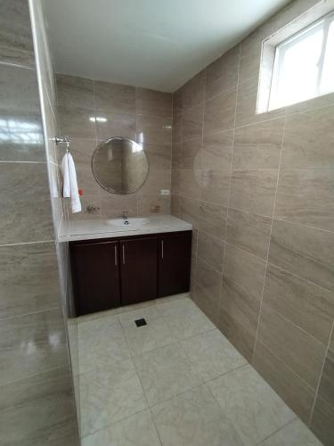 a bathroom with a sink and a mirror at Hotel El Bosque Valledupar in Valledupar