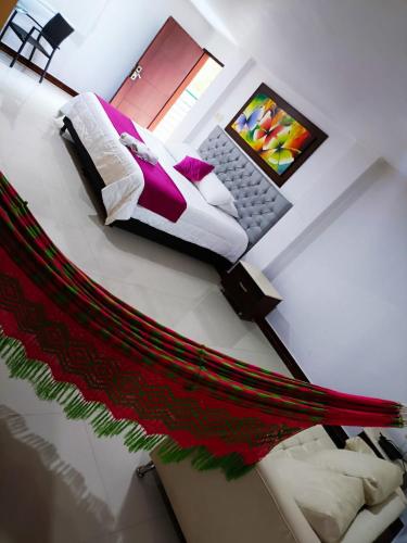 a view of a bedroom with a bed and a laptop at Hotel El Bosque Valledupar in Valledupar
