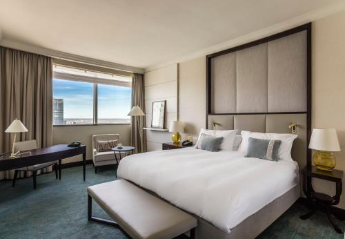 a hotel room with a large bed and a desk at InterContinental Warszawa by IHG in Warsaw