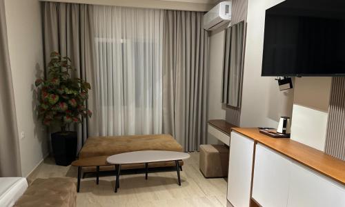 a hotel room with a couch and a table in a room at Anchor Luxury Rooms in Vlorë