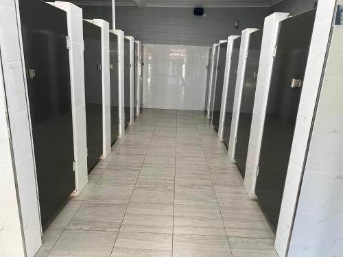 a hallway of stalls in a locker room at Whyalla Caravan And Tourist Park in Whyalla