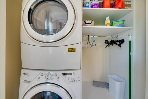 a washing machine and a washer in a bathroom at Luxe Spring Hill Home with Patio and Dock! in Spring Hill