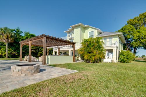 a house with a fire pit in the yard at Luxe Spring Hill Home with Patio and Dock! in Spring Hill