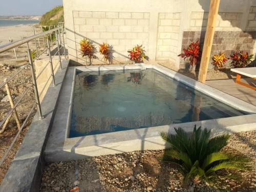 a small swimming pool in front of a house at La Casa de David in Zorritos